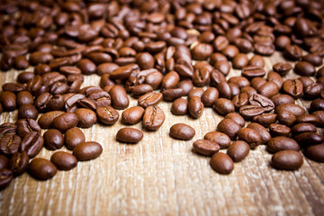 Coffee seeds on wooden surface texture. 