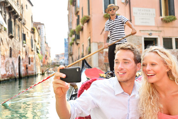 Travel couple in Venice on Gondole ride romance