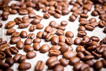 Coffee seeds on wooden surface texture. 