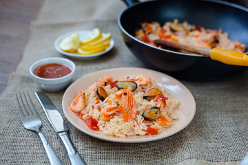 Spanish dish paella with seafood, shrimps in pan