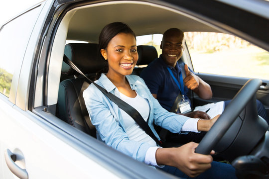 young african woman taking driving lessons