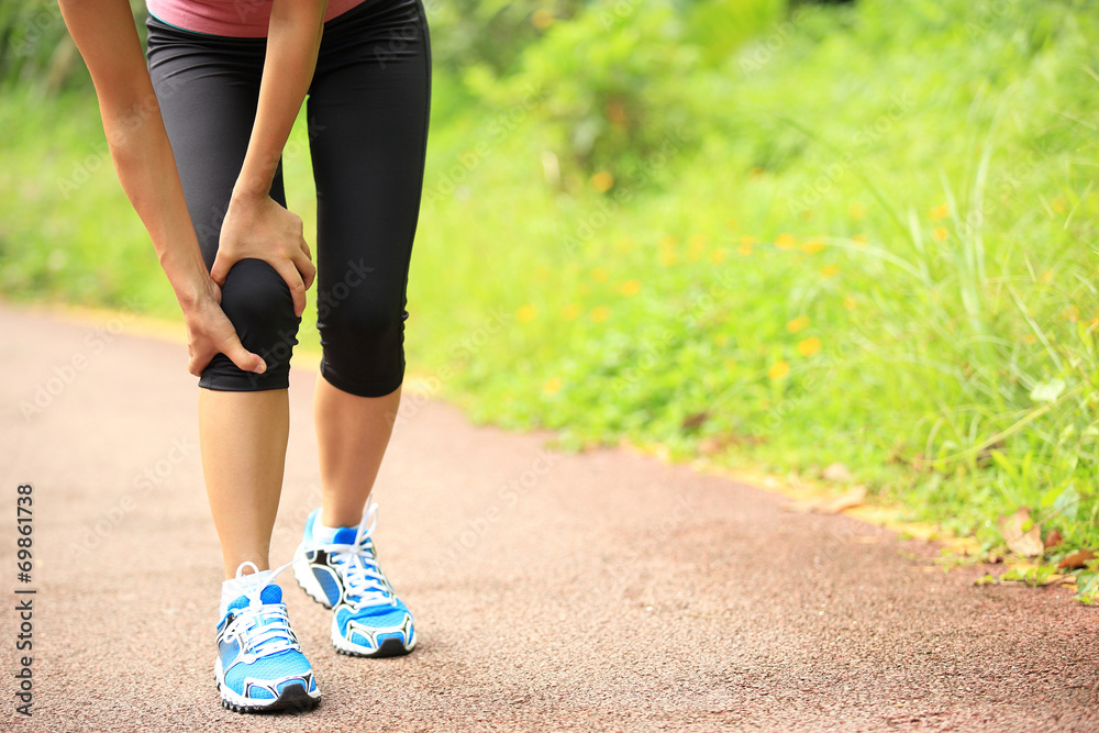 Canvas Prints woman runner hold her sports injured knee 