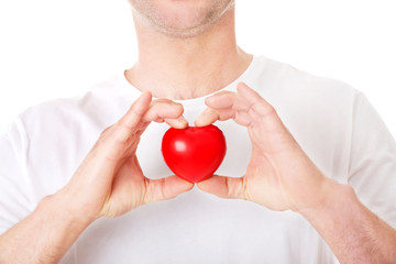 Young man holding a red heart