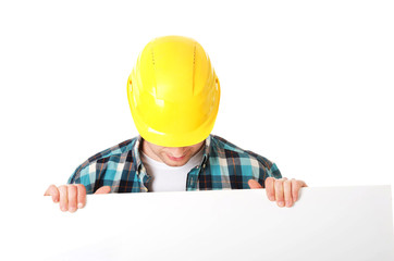 Happy worker presenting empty banner.