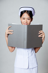 Young Asian nurse smile with a folder