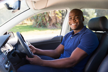 african man inside his new car