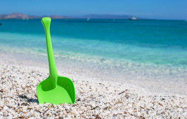 Fototapeta na wymiar Summer kid's beach toy in the white sand