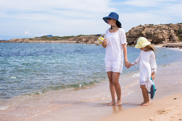 Young mother and her adorable little daughter during summer