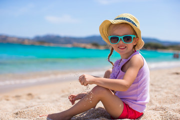 Adorable little girl at tropical beach during European vacation