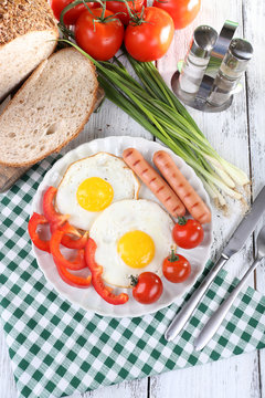 Scrambled eggs with sausage and vegetables served