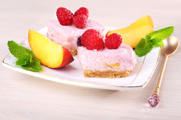 Cake with fruits and berries on plate on wooden background