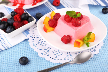 Cakes with fruit and berries on plate on lace napkin