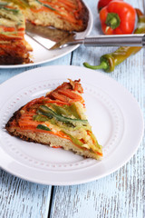 Piece of casserole with vegetables on plate on table close-up