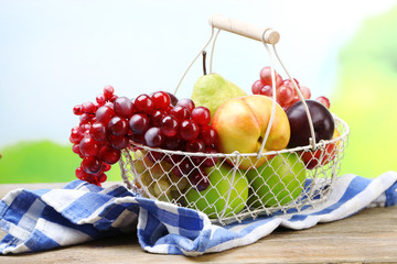 Assortment of juicy fruits in wicker basket