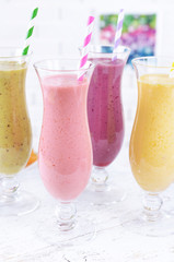 Delicious berry cocktails on table on brick wall background