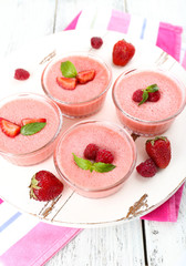 Delicious berry mousse in bowls on table close-up