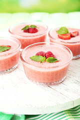 Delicious berry mousse in bowls on table close-up