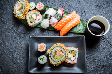 Sushi with soy sauce on black rock