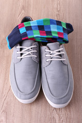 Top-Siders and socks on wooden background