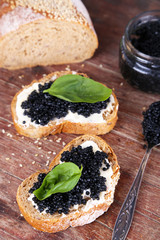 Slices of bread with butter and black caviar