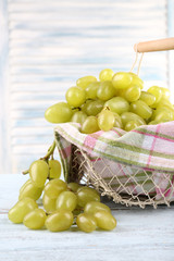 Ripe grapes in metal basket with napkin