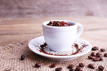 Mug of coffee beans and ground coffee