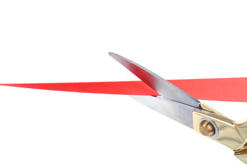 Scissors cutting red ribbon isolated on white