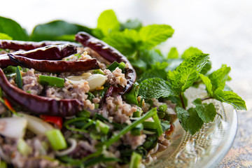 Spicy minced pork salad with dried chili and garnished