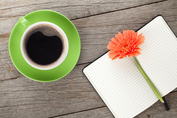 Blank notepad, coffee cup and orange gerbera flowers