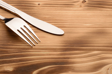 Knife and fork set on a wooden vintage table