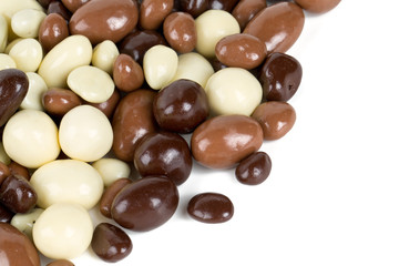 chocolate covered nuts and raisins isolated on white