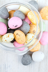 candies in a glass dish on wooden table