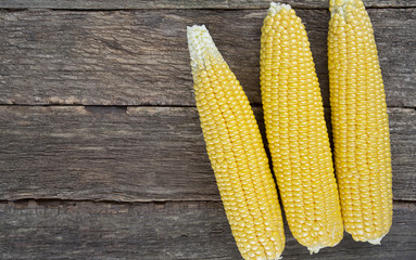 corn cobs on wooden surface