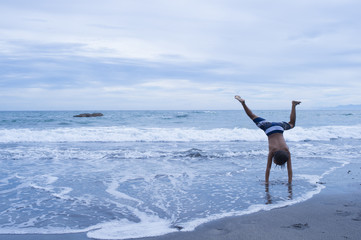 Boy to a cartwheel in beach