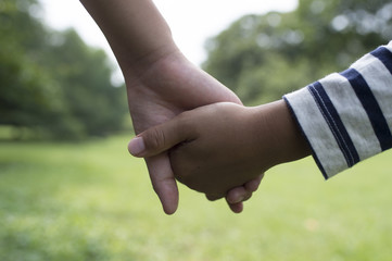 Children holding hands in field