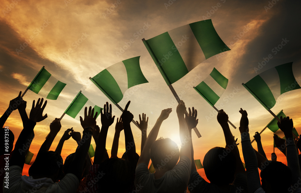 Wall mural silhouettes of people holding flag of nigeria - Wall murals