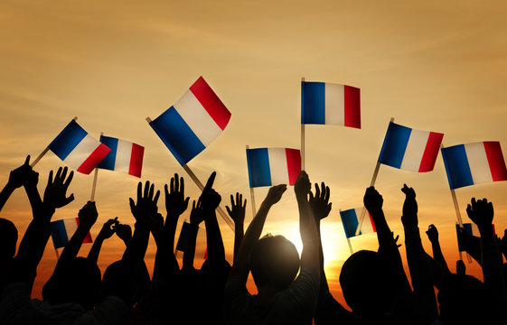 Group of People Waving French Flags in Back Lit