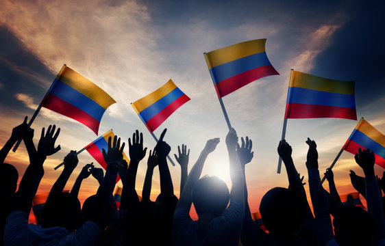 Silhouettes of People Holding Flag of Colombia