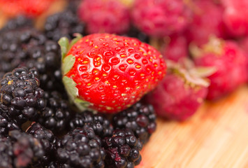 Mix of berries on a wooden table