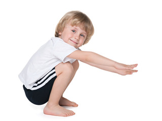 Preschool boy performs exercises - 69875306