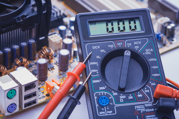 Close-up of multimeter on PCB plate