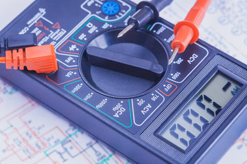 multimeter on the white laptop. close-up