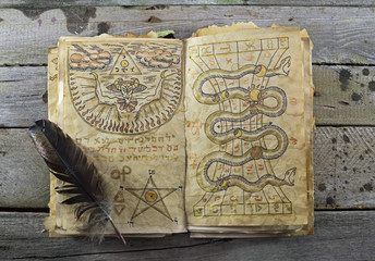 Magic book on wooden table 2 - obrazy, fototapety, plakaty