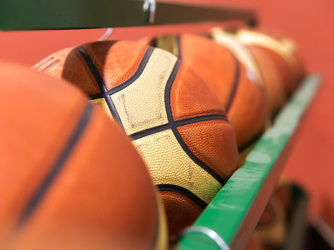 row of basket balls in gymnasium