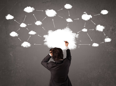 Businessman sitting with cloud technology above his head