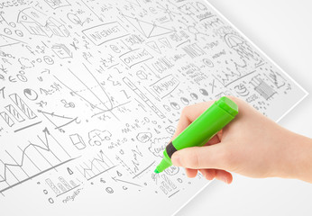 Human hand sketching ideas on a white paper