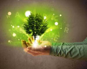 Glowing tree growing in the hand of a woman