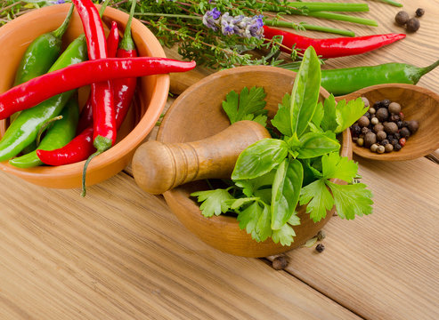 Herbs and peppers on  wooden background