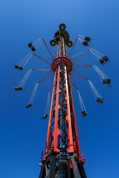Flying swing carousel against blue sky