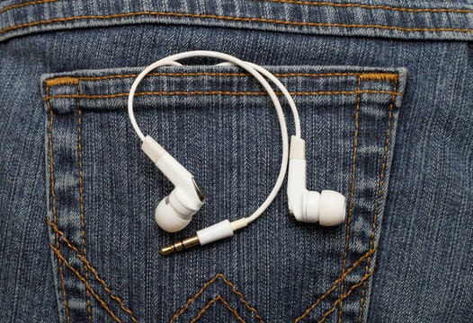 Vacuum headphones white in jeans pocket